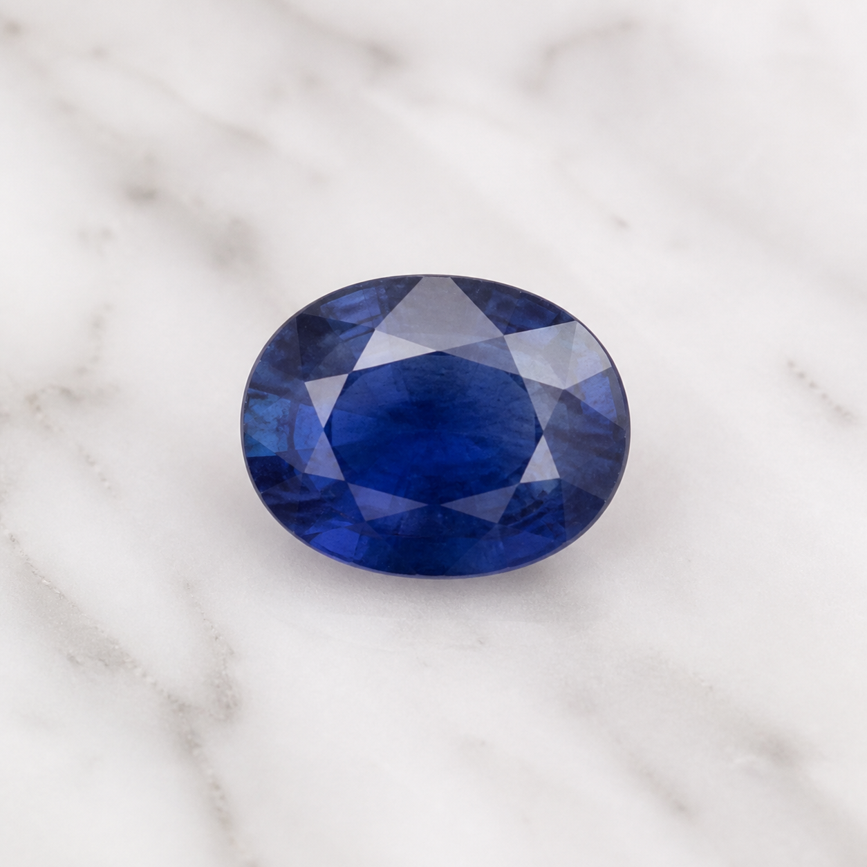 Natural blue sapphire shown on a neutral background
